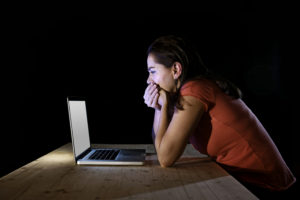 depressed worker or student woman working with computer alone late night in stress | 92.5 The Beat
