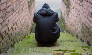 Addiction,Concept.,A,Drug,Addict,In,A,Hood,Sits,In - 92.5 The Beat