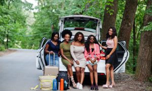 Group,Of,Five,Happy,African,American,Traveler,Girls,Sitting,In - 92.5 The Beat