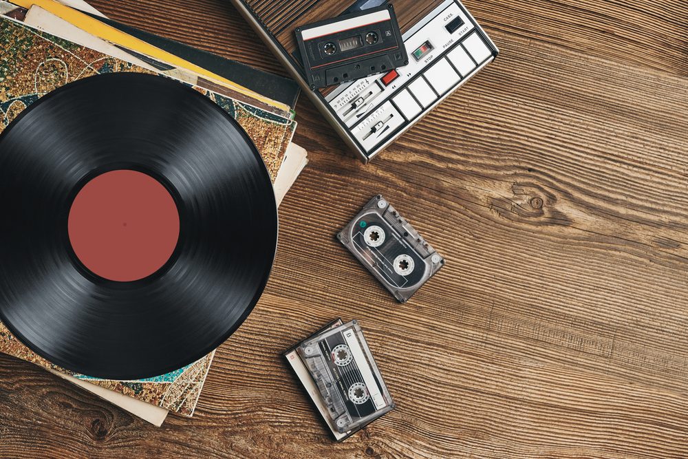 VinylRecordsCassetteTapesAndCassetteRecorderOnWoodenTable - 92.5 The Beat Classic Hip-Hop Albums released in December