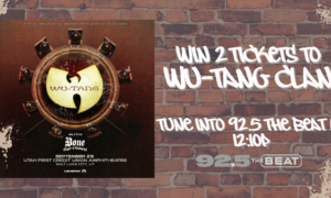 Promotional poster on a brick wall advertising a Wu-Tang Clan event with date, venue (Utah First Credit Union Amphitheatre, Salt Lake City, UT), and sponsor info; right side invites listeners to win 2 tickets on 92.5 The Beat.